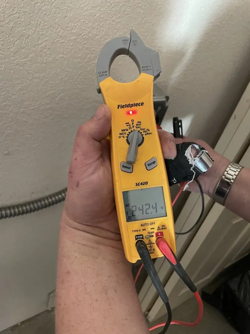 Voltage testing with clamp meter during Outlet Installation in San Benito